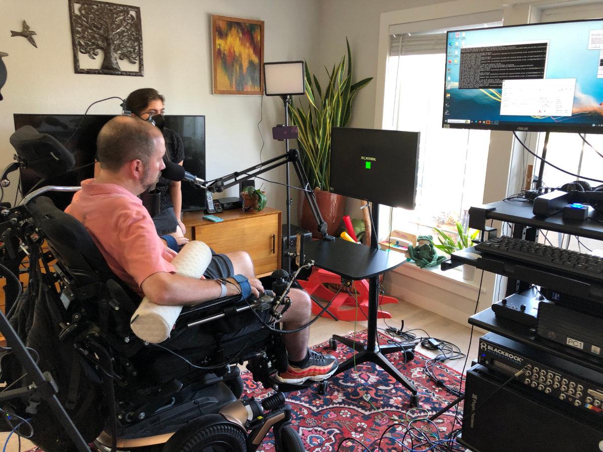 The BCI setup and the study participant using the voice synthesis tech